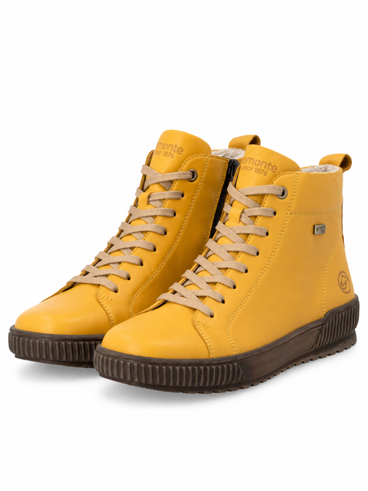 A pair of high-top yellow boots with beige laces, dark brown ribbed soles, and a black zipper, shown on a white background.